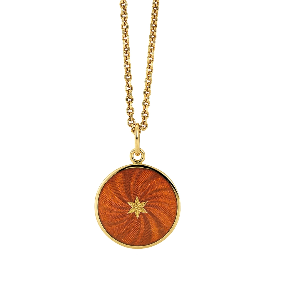 Small round pendant made of yellow gold, about the size of a small coin. The front shimmers in autumn yellow translucent enamel with a fine wave pattern. At the center lies a tiny hexagonal gold insert shaped as a star with microscopic relief details.