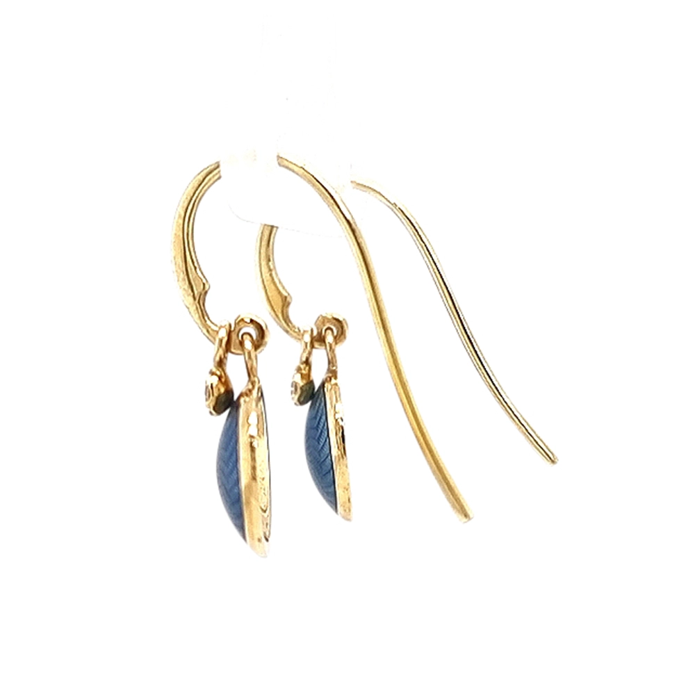 Round Candy ear hooks in yellow gold with medium blue enamel over windmill guilloché, two diamonds, one freely suspended from the hook fitting, diameter 10 mm.