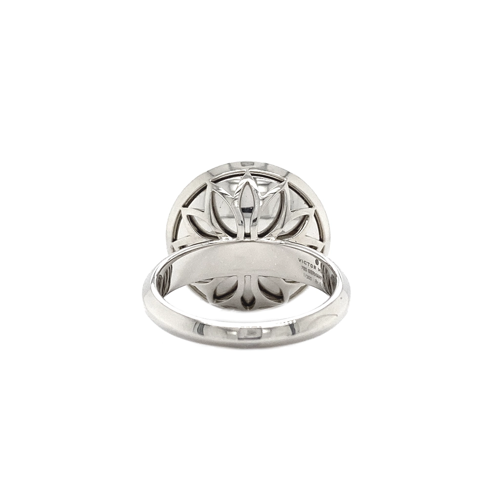 Ring in white gold with a round ring head. The ring head is concave and covered with translucent purple vitreous enamel, beneath which a fine windmill guilloché pattern is visible. A single small diamond is set at the centre of the enamel surface as a subtle focal point. The design appears calm, geometric, and balanced.