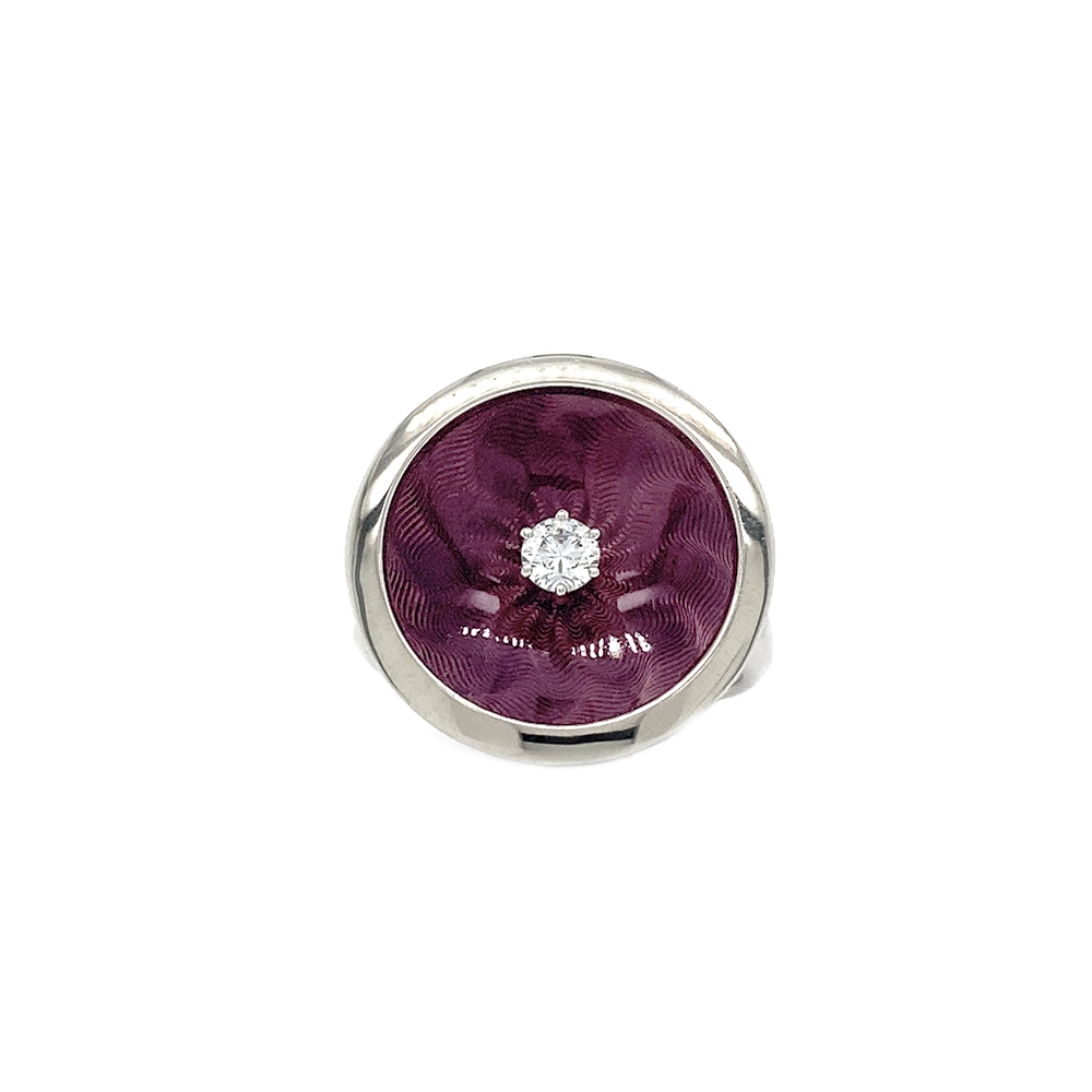 Ring in white gold with a round ring head. The ring head is concave and covered with translucent purple vitreous enamel, beneath which a fine windmill guilloché pattern is visible. A single small diamond is set at the centre of the enamel surface as a subtle focal point. The design appears calm, geometric, and balanced.