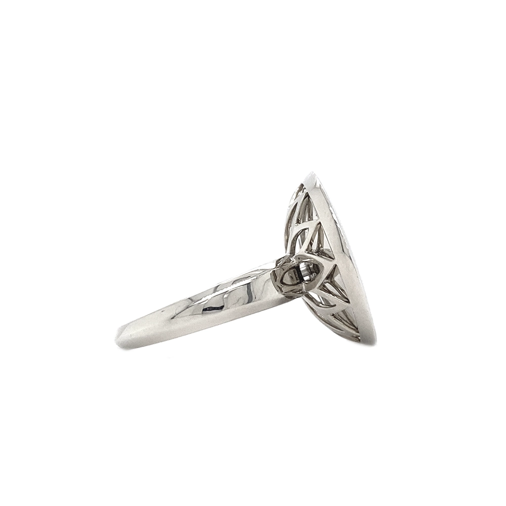 Ring in white gold with a round ring head. The ring head is concave and covered with translucent purple vitreous enamel, beneath which a fine windmill guilloché pattern is visible. A single small diamond is set at the centre of the enamel surface as a subtle focal point. The design appears calm, geometric, and balanced.