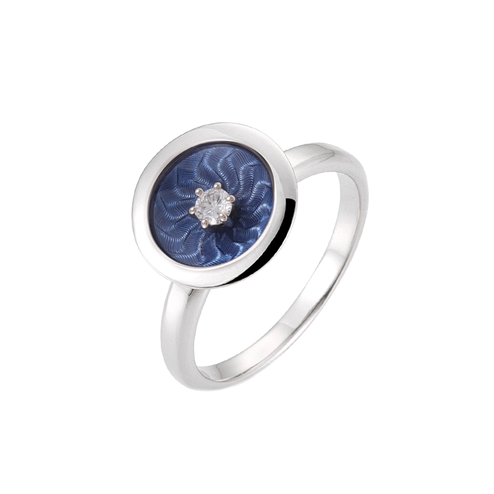 Ring in white gold with a round ring head. The ring head is concave and covered with translucent medium blue vitreous enamel, beneath which a fine windmill guilloché pattern is visible. A single small diamond is set at the centre of the enamel surface as a subtle focal point. The design appears calm, geometric, and balanced.